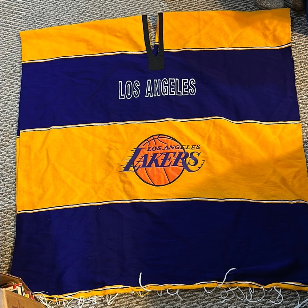 Great shape. One size lakers poncho